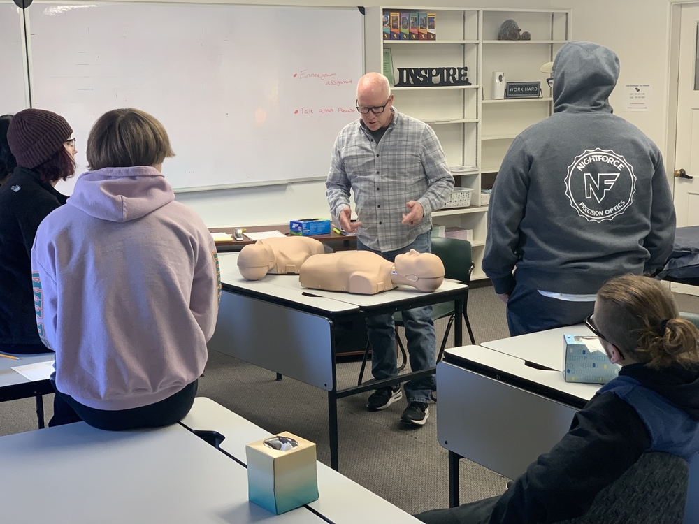 Tim Nelson works with students in CPR class
